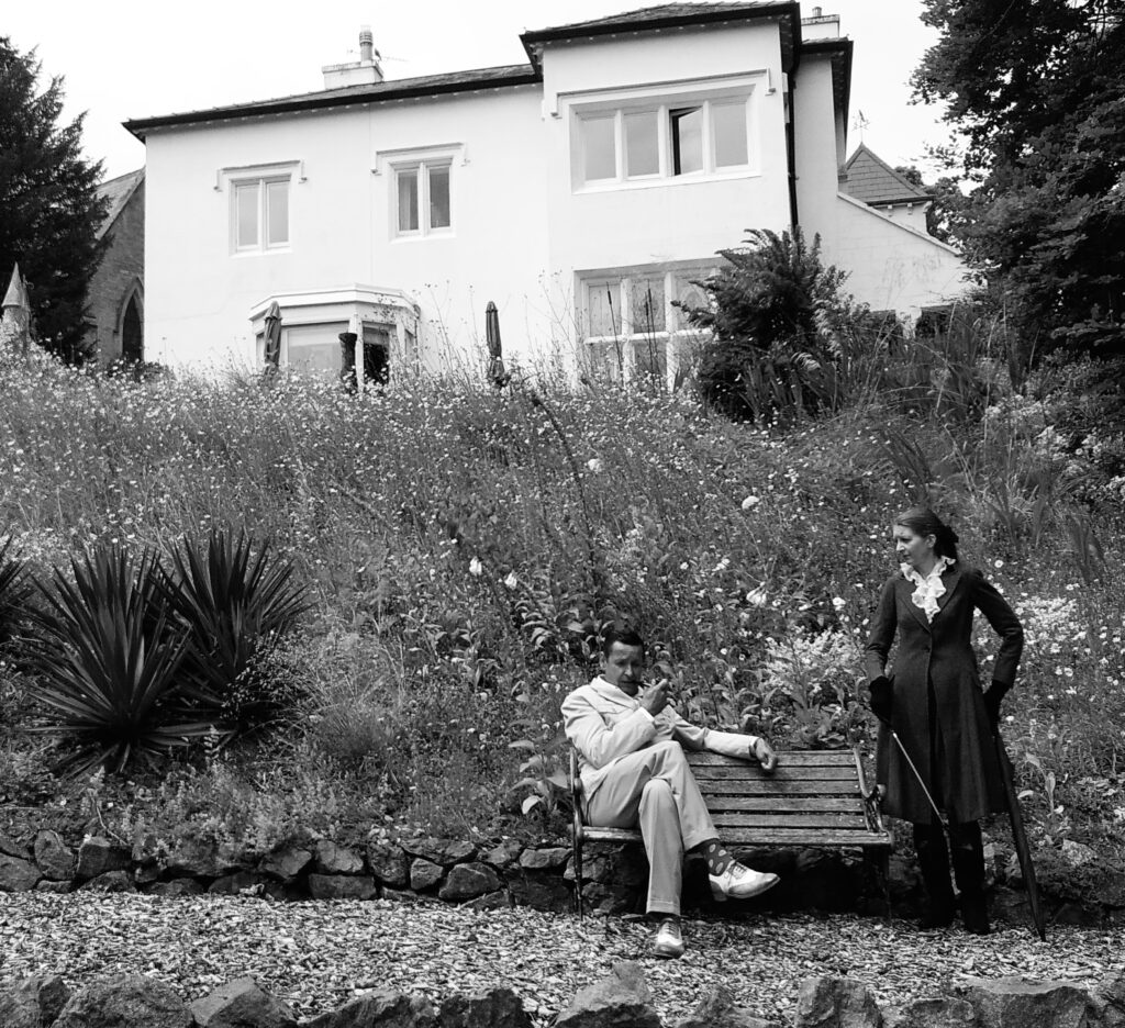 Two suspects talking in the garden of The Dell House